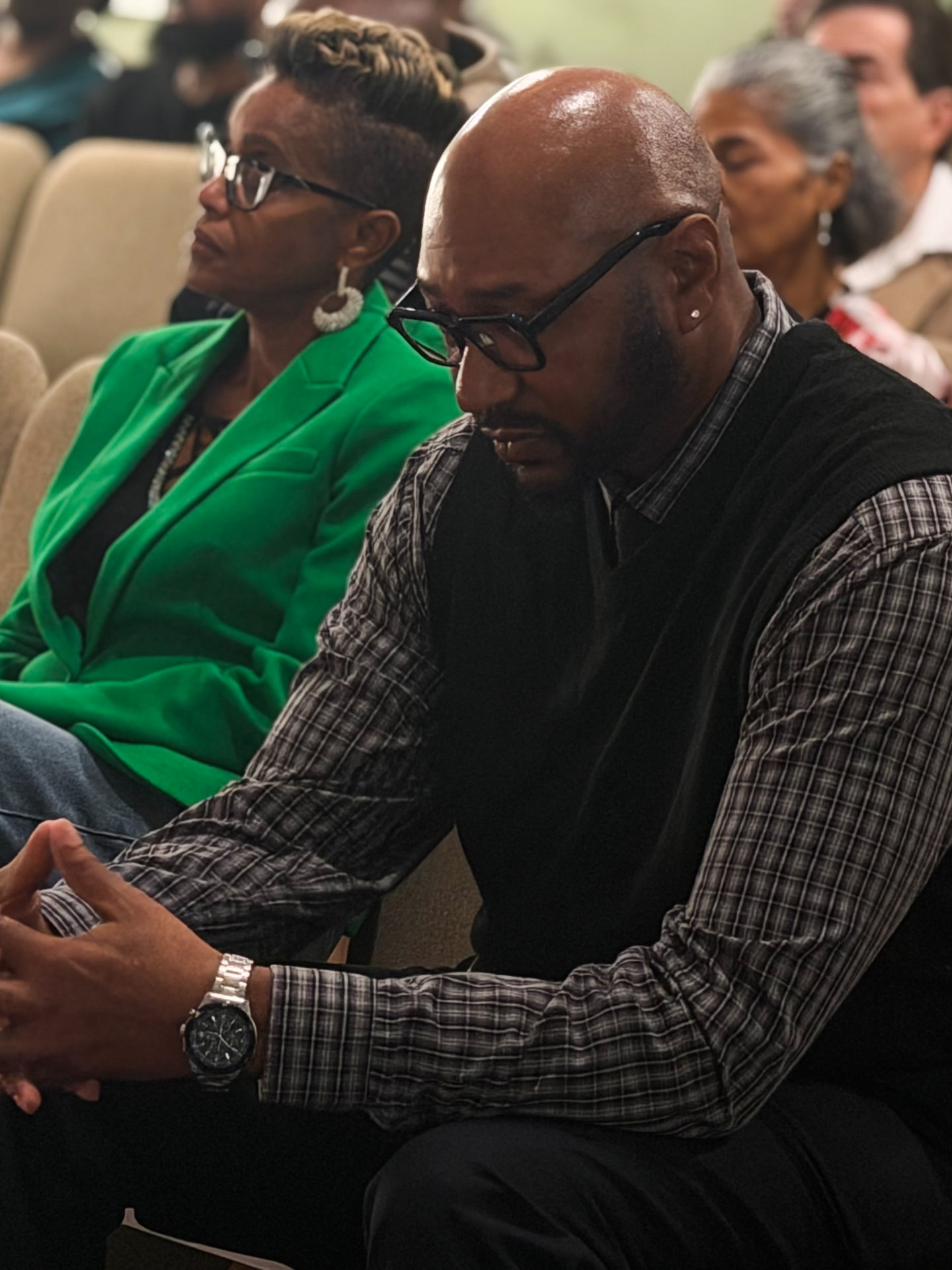 Members of the congregation seated in prayer