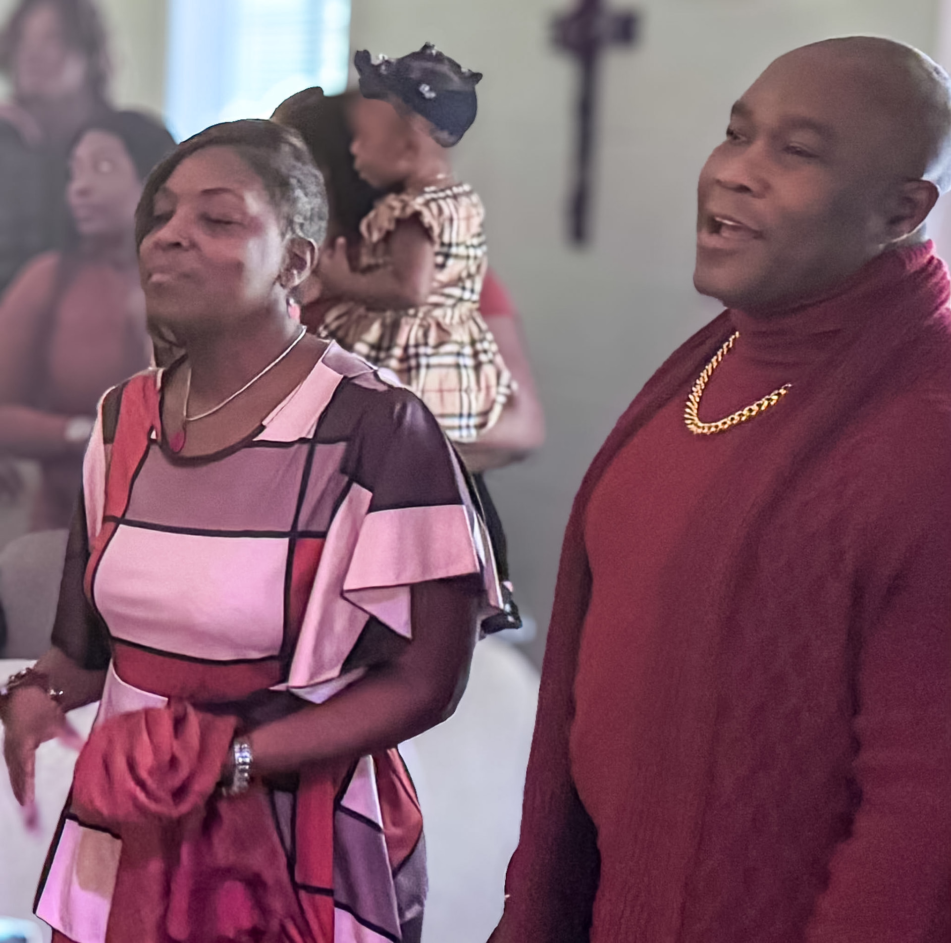 The congregation sings and prays together during worship